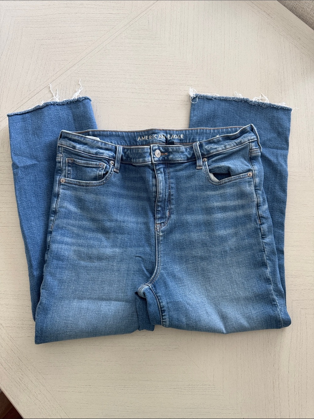 American Eagle Outfitters Light Blue High-Rise Slim Jeans with Raw Hem